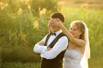 Bride and Groom Having Fun in the Meadow
