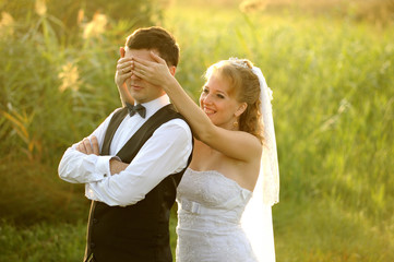 Bride and Groom Having Fun in the Meadow
