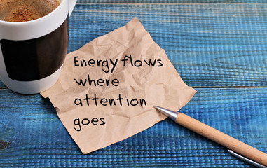 Inspiration motivation quotation Energy flows where attention goes and cup of coffee - obrazy, fototapety, plakaty