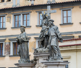 Statue of the Holy Savior with Cosmas and Damian. Text In this cross - our salvation. Charles Bridge in Prague