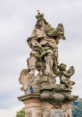 Fototapeta na wymiar Statue of St. Ludmila, her grandson St. Wenceslas on the Charles Bridge in Prague, Czech