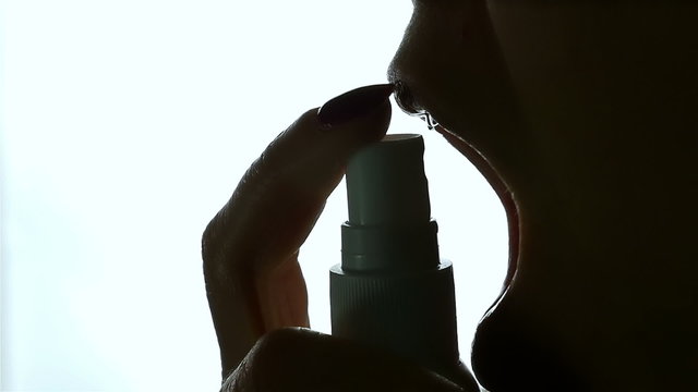 Timelaps of Unrecognizable woman uses medical inhalation sprayer