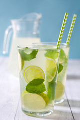 Summer drink. Fresh mojito with lime and mint. Blue background
