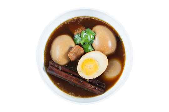 Eggs boiled in the gravy with spices isolated on white. Thai cui