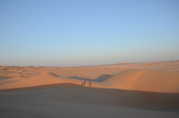 Sand dunes with people shadow in Oman