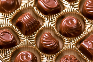 Delicious chocolate candies on wooden background