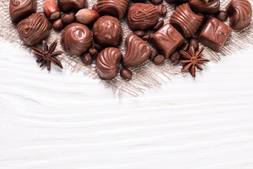 Fototapeta na wymiar Delicious chocolate candies on wooden background
