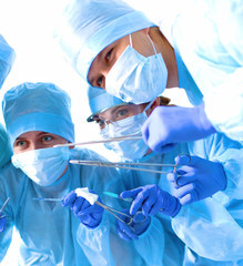 Team of surgeon in uniform perform operation on a patient at cardiac surgery clinic