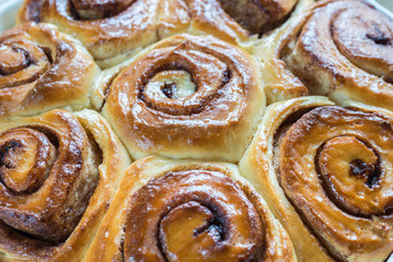 Cinnamon rolls on the wooden background