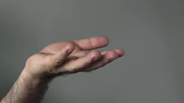 Man hand begging on a grey background. Concepts and ideas with copy space