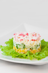 Crab sticks salad on white tablecloth