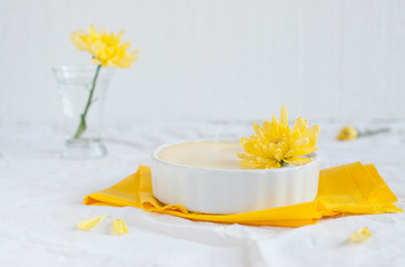 Obraz na płótnie Canvas Portion cheesecake on white and yellow background