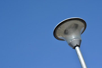 Modern street lamp against blue sky