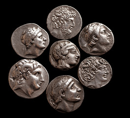 Silver coins of ancient Greece on a black background