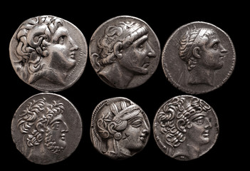 Ancient greek silver coins with portraits of rulers and gods