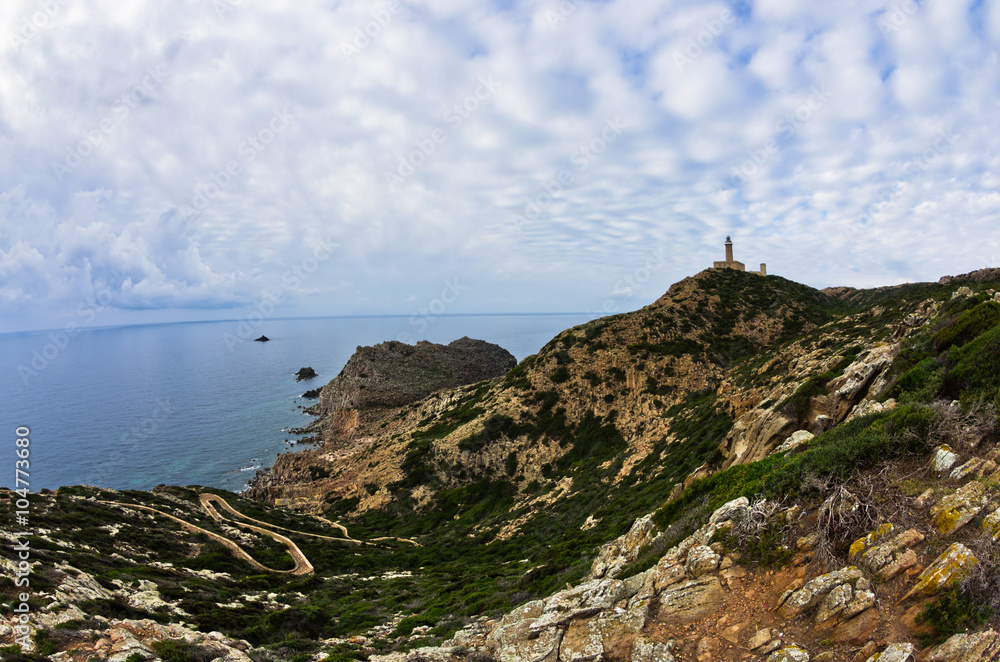 Wall mural lighthouse at capo sandalo on west coast of san pietro island, sardinia, italy