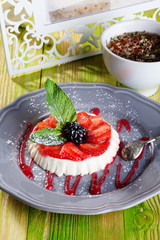 cake panna cotta, cheese strawberries and mint on a gray plate Provence still life dessert