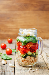 White beans cucumber tomato red pepper feta spinach salad in a j