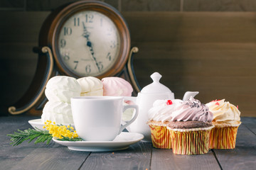 clock and breakfast on dark wooden table
