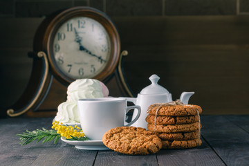clock and breakfast on dark wooden table