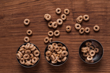 Cereals in metal bowl on brown wooden table