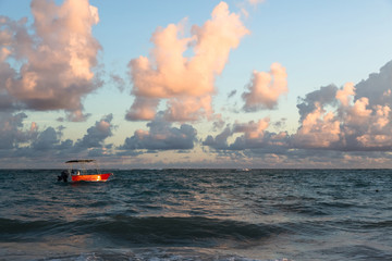 Red boat on colorful water of Atlantic ocean, Dominican Republic