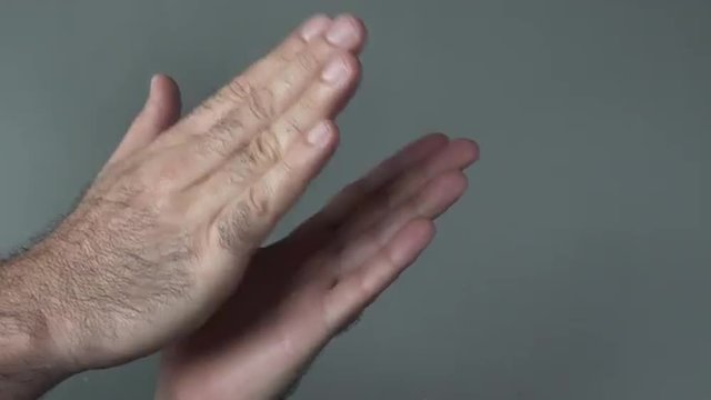 Man hands clapping on a grey background. Concepts and ideas with copy spaceThis video is about W