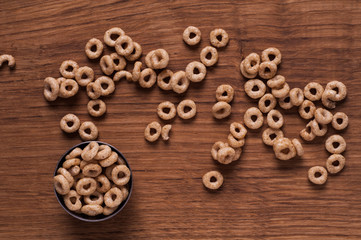 Cereals in metal bowl on brown wooden table