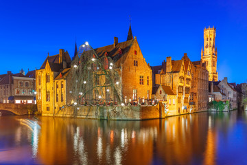 Fototapeta na wymiar Scenic panorama with medieval fairytale town and tower Belfort from the quay Rosary, Rozenhoedkaai, in the evening, Bruges, Belgium