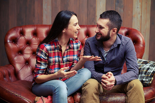 couple sitting on couch and have a nice conversation
