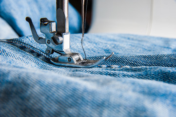 Sewing machine and blue jeans fabric.