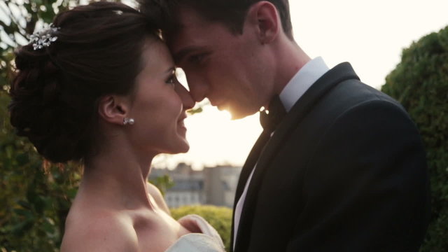 Beautiful bride and groom softly looking on each other close up