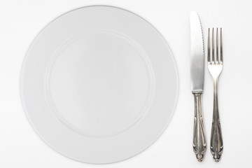 empty plate with beautiful silver knife and fork
