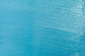 Cleaning background texture - chemical soap detergent foam on a clear glass
