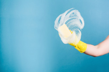 Cleaning conept - hand cleaning glass window pane with detergent and rubber aluminium wiper