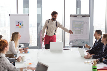 Hipster business man presenting the project in modern office.