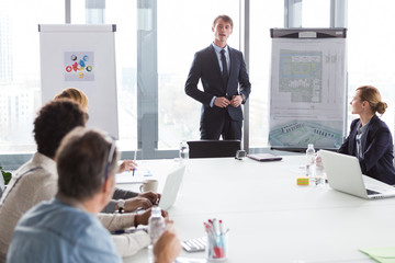 Business man talking about project during meeting in modern office.