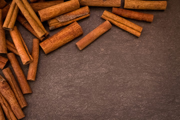 Cinnamon sticks on light brown background
