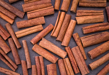 Cinnamon sticks on light brown background