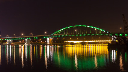 Fototapeta na wymiar Old Tram bridge across the Sava river in Belgrade shot at night