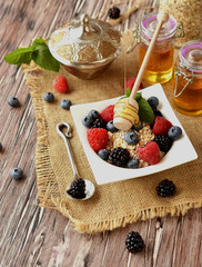 oatmeal with berries on a wooden table, selective focus