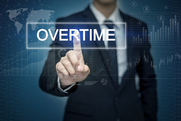 Businessman hand touching OVERTIME  button on virtual screen