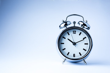 Metal Alarm clock work time on white background 10 am.