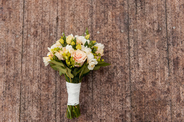 Bridal bouquet of roses on a  wooden planks