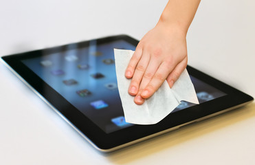 hand with white wet wipe tablet cleaning