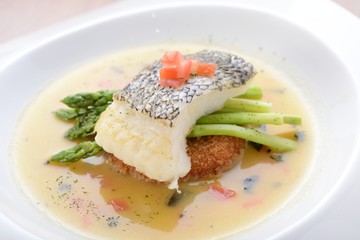 Braised cod fish on top of Asparagus and potato