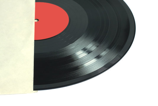 Part of black long-play vinyl record with red label isolated on white background. Photo closeup