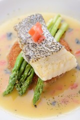 Braised cod fish on top of Asparagus and potato