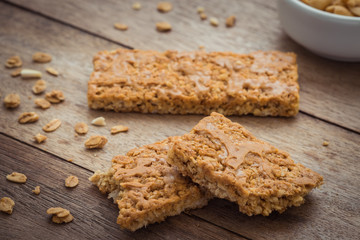 Granola bars on wooden table and peanuts