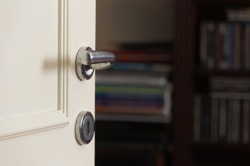 open and closed white doors close up of  handle and keyhole